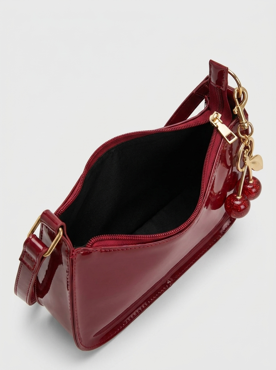 Cherry Charm Bag open - view into the black lining of the cherry red patent bag