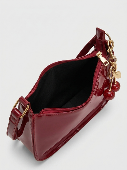 Cherry Charm Bag open - view into the black lining of the cherry red patent bag