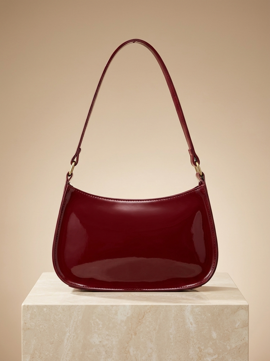 Cherry Charm Bag back view - cherry red patent bag with smooth back panel on stone pedestal
