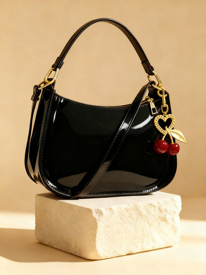 Fleur bag charm hanging on a bag handle