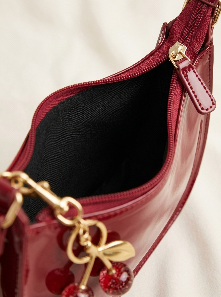 Close-up of zipper and black lining on the Cherry Charm Bag in cherry red