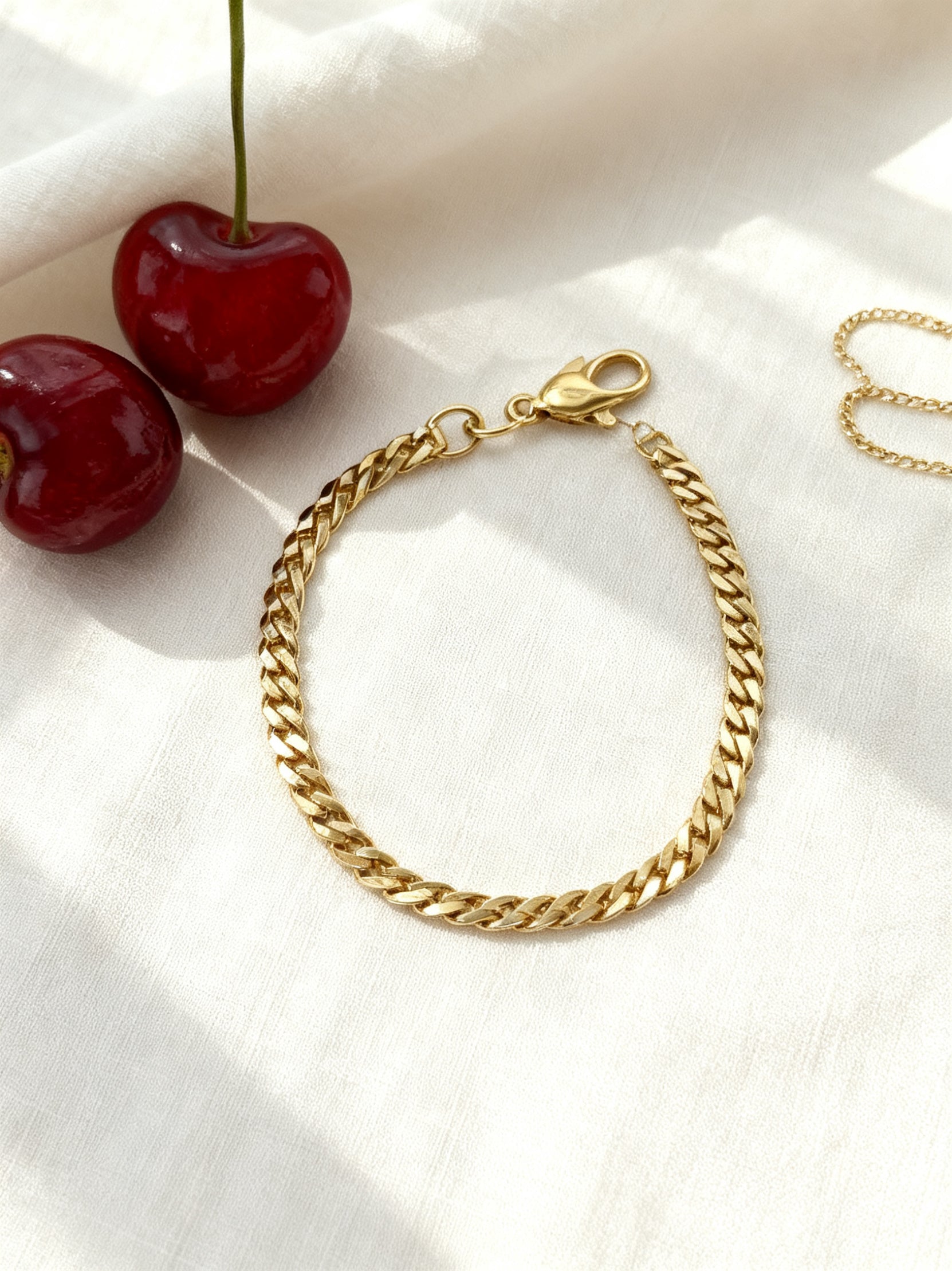 Étoile gold bracelet stainless steel nickel-free flat lay with cherries