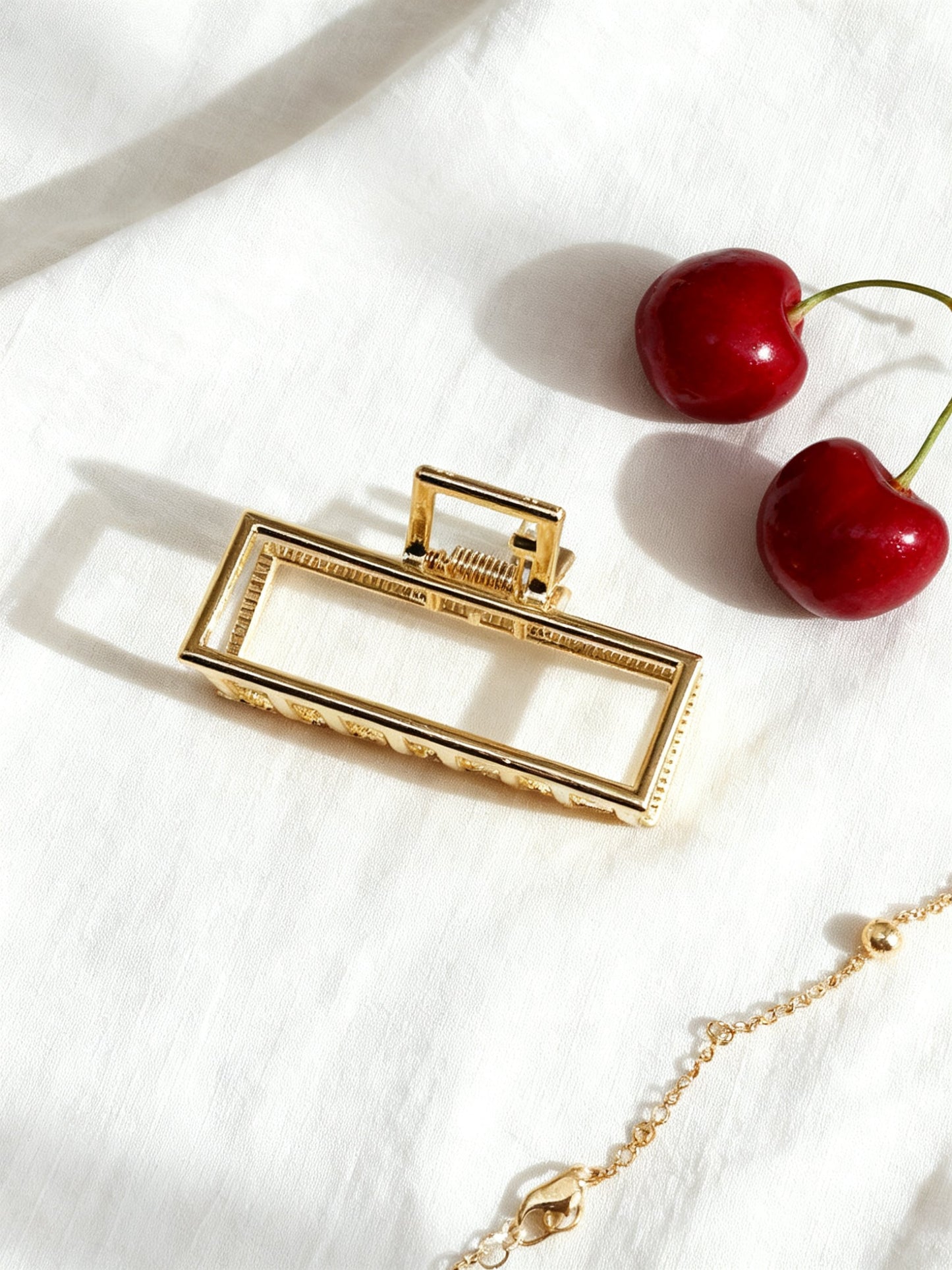 Chérie claw clip gold geometric flat lay with cherries