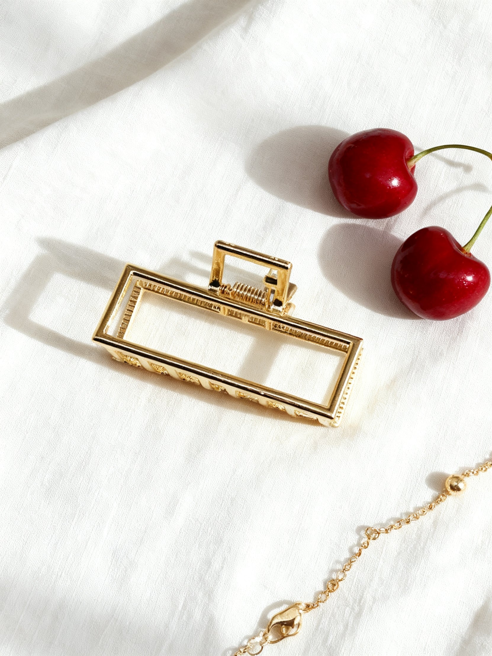 Chérie claw clip gold geometric flat lay with cherries