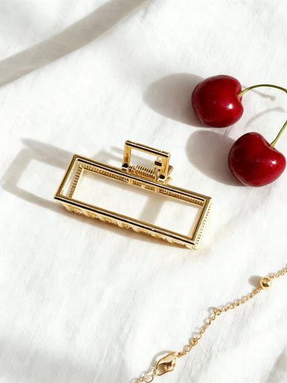 Chérie claw clip gold geometric flat lay with cherries